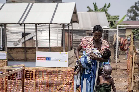 Mpox outbreak: A woman with her children after a treatment at a clinic in Munigi